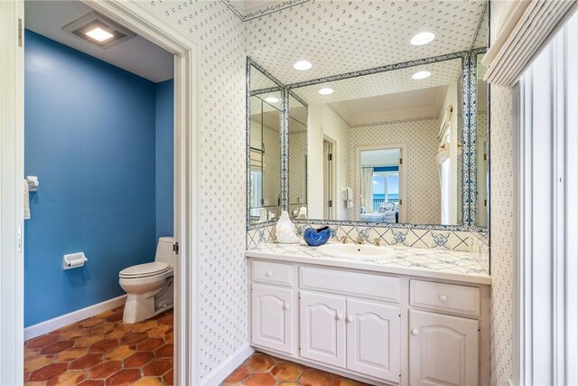 596 Ocean Rd, Vero Beach, FL 32963 - bathroom with a stall shower, baseboards, toilet, vanity, and wallpapered walls