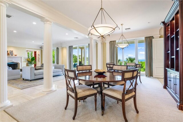 596 Ocean Rd, Vero Beach, FL 32963 - dining area featuring decorative columns, plenty of natural light, ornamental molding, recessed lighting, and a fireplace