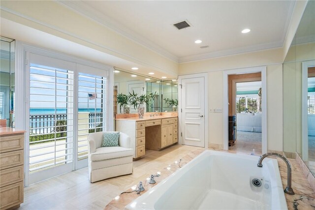596 Ocean Rd, Vero Beach, FL 32963 - full bath with ornamental molding, vanity, a bath, and recessed lighting