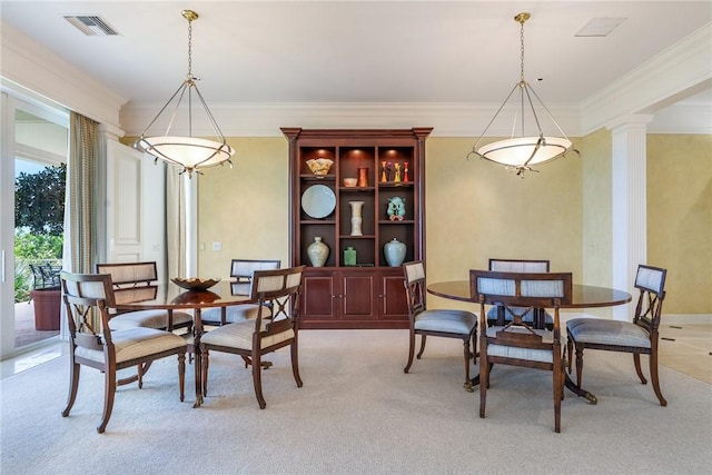 596 Ocean Rd, Vero Beach, FL 32963 - dining space with crown molding, light carpet, and decorative columns