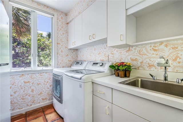 596 Ocean Rd, Vero Beach, FL 32963 - laundry room featuring cabinet space, washing machine and dryer, wallpapered walls, and baseboards