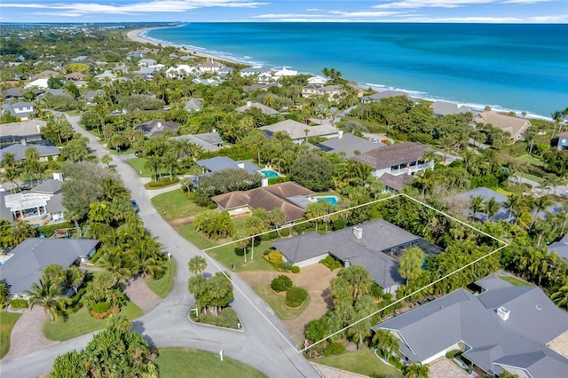 birds eye view of property featuring a view of the beach and a water view