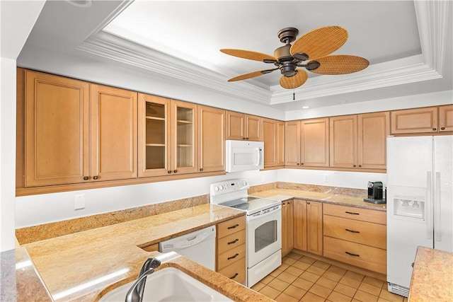 kitchen with light tile patterned floors, white appliances, ornamental molding, a tray ceiling, and glass insert cabinets