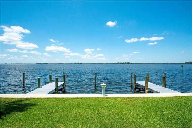 dock area featuring a water view and a yard