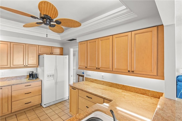 kitchen featuring light tile patterned floors, white refrigerator with ice dispenser, visible vents, a raised ceiling, and crown molding