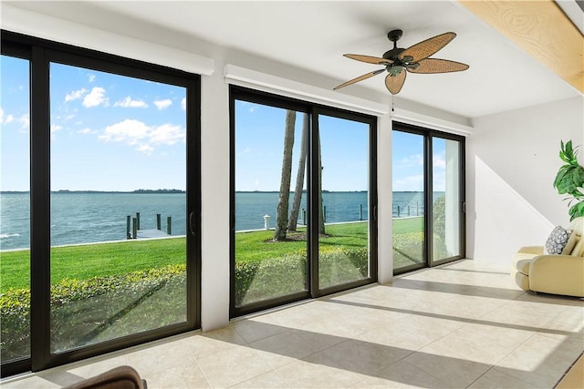 interior space featuring a water view, plenty of natural light, and ceiling fan