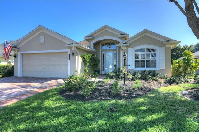 single story home with a garage and a front yard