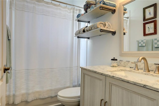 full bathroom featuring vanity, shower / tub combo, and toilet