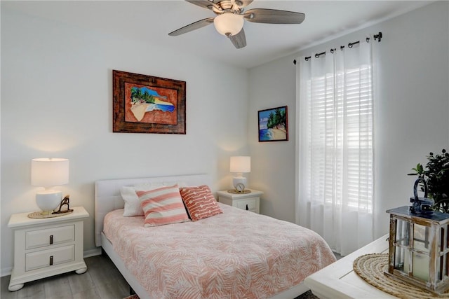 bedroom featuring multiple windows, wood-type flooring, and ceiling fan