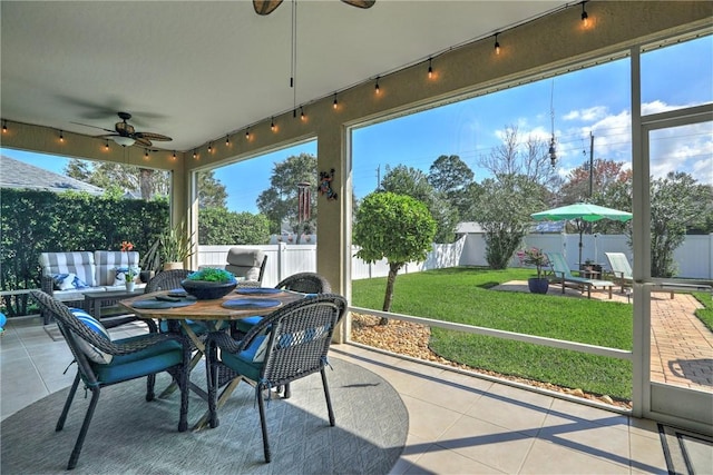 sunroom with plenty of natural light and ceiling fan