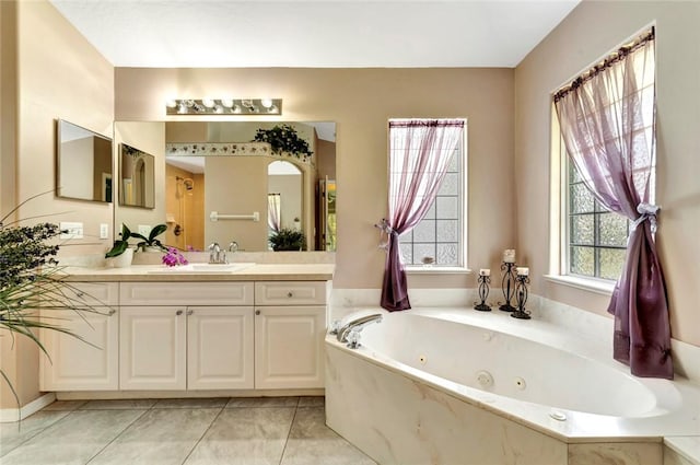 8145 95th Ct, Vero Beach, FL 32967 - bathroom featuring tile patterned flooring, a whirlpool tub, and vanity