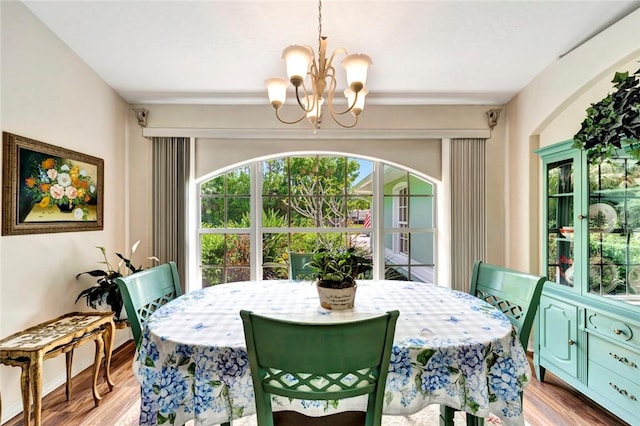 8145 95th Ct, Vero Beach, FL 32967 - dining room with a notable chandelier and wood finished floors