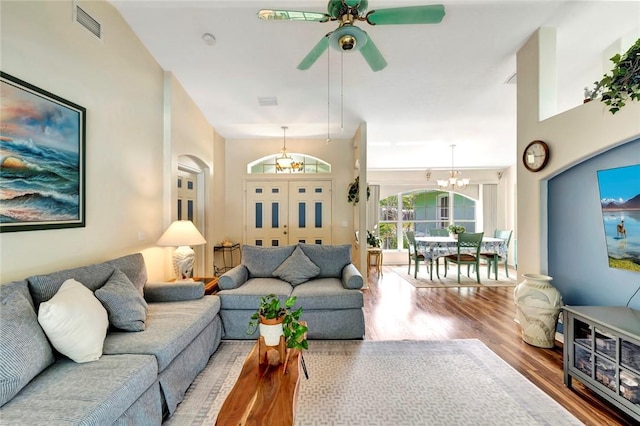 8145 95th Ct, Vero Beach, FL 32967 - living area featuring wood finished floors, visible vents, and ceiling fan with notable chandelier