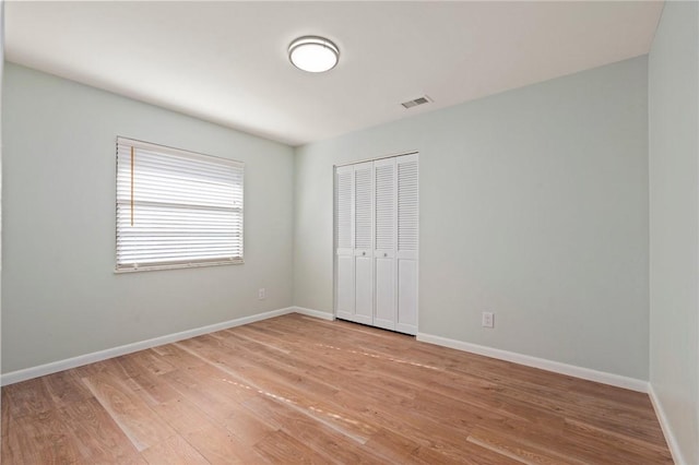 2906 1st St, Vero Beach, FL 32968 - unfurnished bedroom with visible vents, baseboards, light wood-type flooring, and a closet