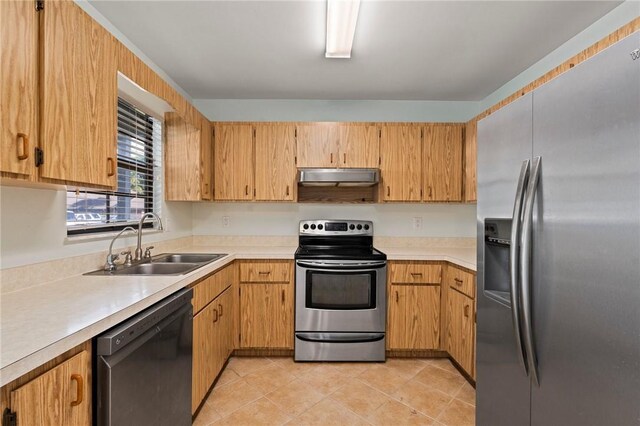 2906 1st St, Vero Beach, FL 32968 - kitchen featuring light countertops, under cabinet range hood, a sink, and stainless steel appliances