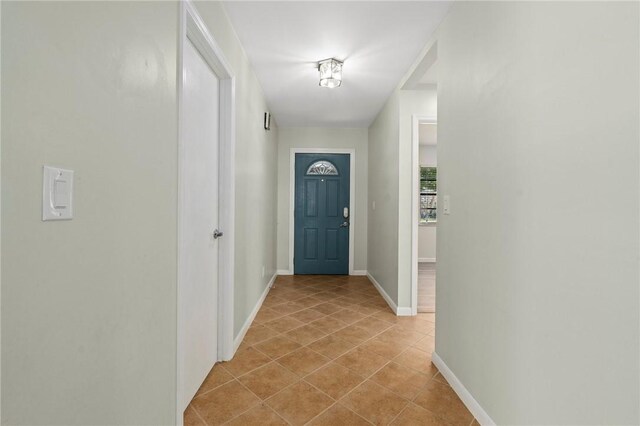 2906 1st St, Vero Beach, FL 32968 - entryway with light tile patterned floors and baseboards