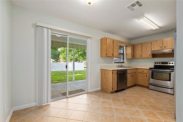2906 1st St, Vero Beach, FL 32968 - kitchen with dishwashing machine, stainless steel electric range oven, visible vents, under cabinet range hood, and light countertops