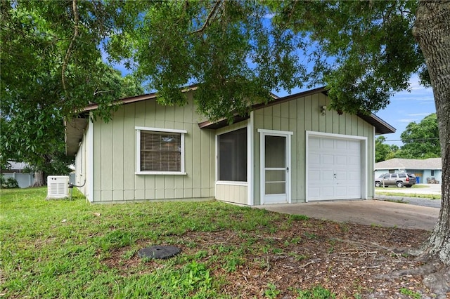 2906 1st St, Vero Beach, FL 32968 - view of front of home featuring driveway, board and batten siding, a front lawn, and a detached garage