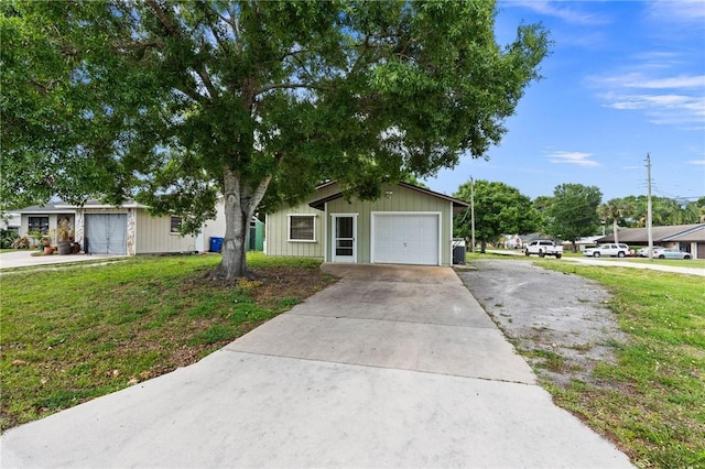 2906 1st St, Vero Beach, FL 32968 - single story home featuring concrete driveway, board and batten siding, a front lawn, and a detached garage