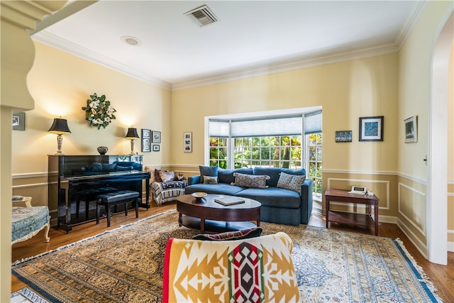 living room featuring hardwood / wood-style flooring and ornamental molding