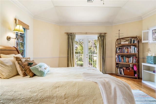 bedroom featuring access to outside, light hardwood / wood-style flooring, and crown molding