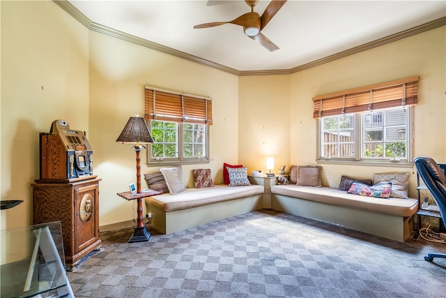 living area featuring plenty of natural light, light carpet, ceiling fan, and crown molding