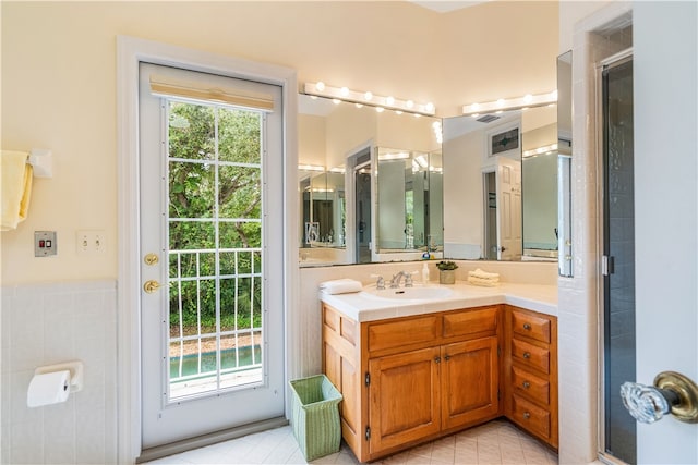 bathroom featuring vanity and a shower with shower door