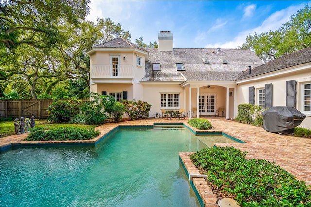 view of swimming pool with area for grilling and a patio area