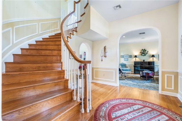 foyer featuring wood-type flooring and ornamental molding