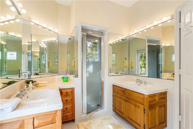 bathroom with vanity, walk in shower, and tile patterned floors