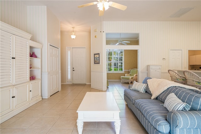 living room with ceiling fan and light tile patterned flooring