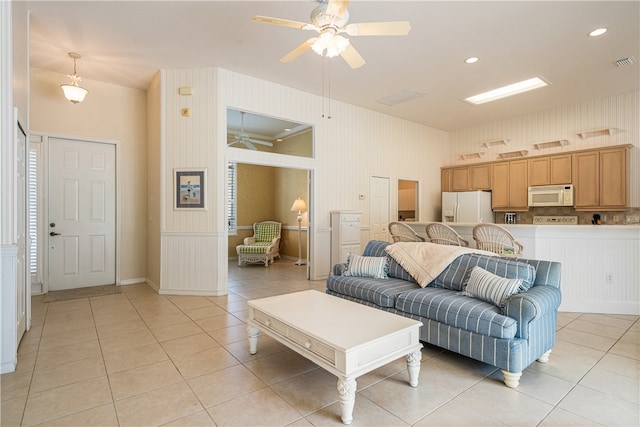 living room with ceiling fan and light tile patterned floors