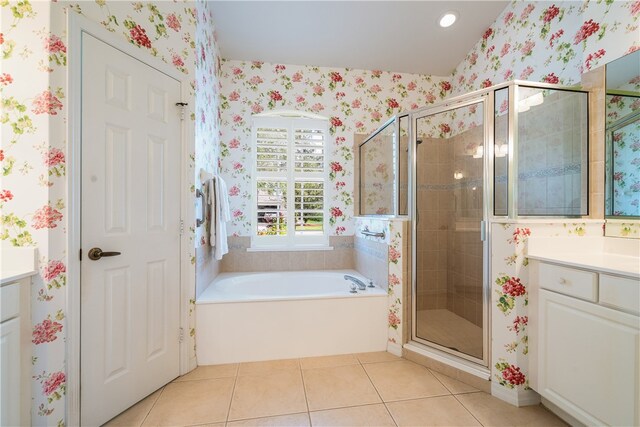 bathroom featuring vanity, tile patterned floors, and plus walk in shower