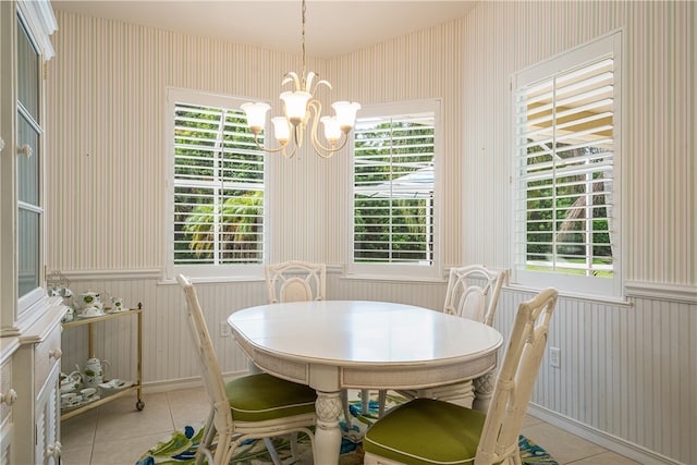 tiled dining space with a notable chandelier