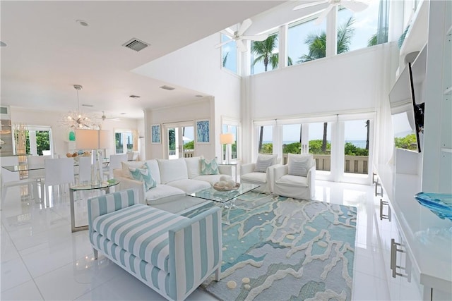 116 Ocean Way, Vero Beach, FL 32963 - living room with tile patterned flooring, ceiling fan, and a chandelier