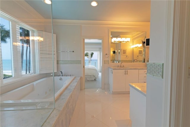 116 Ocean Way, Vero Beach, FL 32963 - ensuite bathroom featuring vanity, healthy amount of natural light, a tub with jets, tile patterned floors, and ornamental molding
