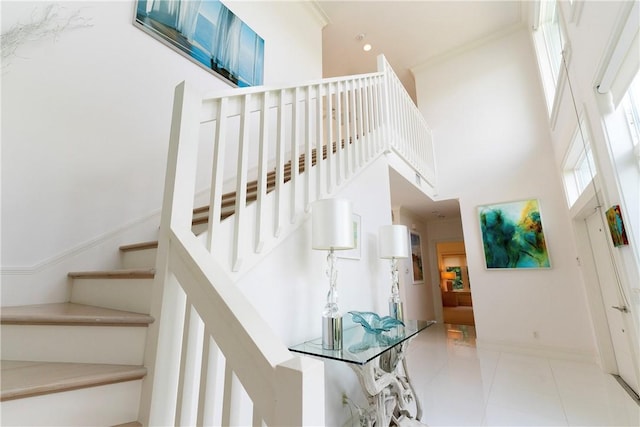 116 Ocean Way, Vero Beach, FL 32963 - stairway featuring a towering ceiling, crown molding, and tile patterned flooring