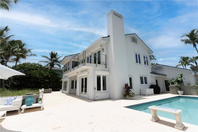 116 Ocean Way, Vero Beach, FL 32963 - back of property featuring a balcony, an outdoor pool, a patio, and a chimney