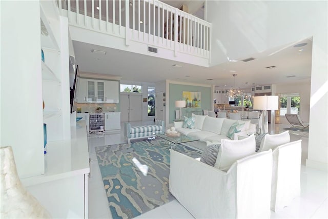 116 Ocean Way, Vero Beach, FL 32963 - living area featuring wine cooler, a chandelier, and a high ceiling