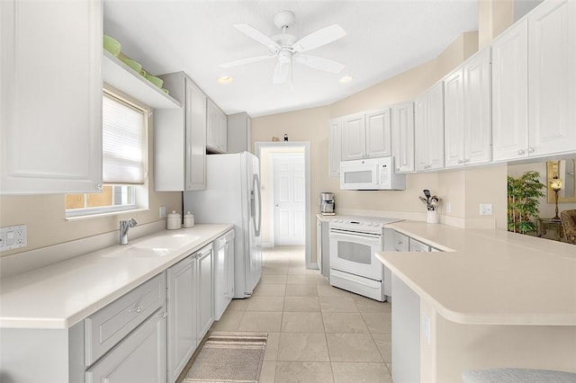 4951 Corsica Sq, Vero Beach, FL 32967 - kitchen with white appliances, a ceiling fan, light tile patterned floors, light countertops, and a peninsula