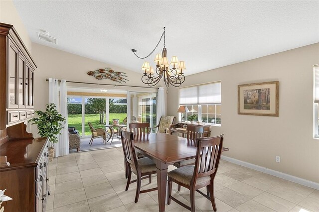 4951 Corsica Sq, Vero Beach, FL 32967 - dining space featuring a textured ceiling, vaulted ceiling, light tile patterned floors, and a chandelier