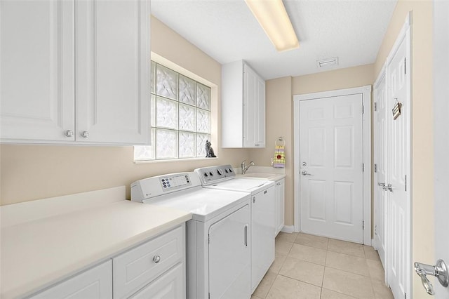 4951 Corsica Sq, Vero Beach, FL 32967 - washroom featuring cabinet space, washing machine and clothes dryer, and light tile patterned flooring