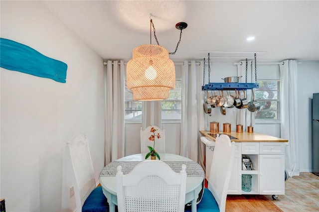 dining space with plenty of natural light and light wood-type flooring