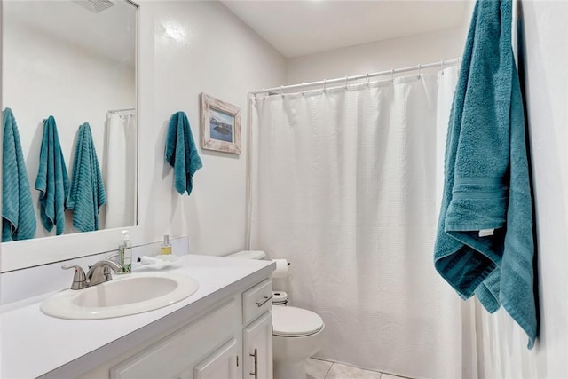 bathroom with tile patterned floors, toilet, and vanity