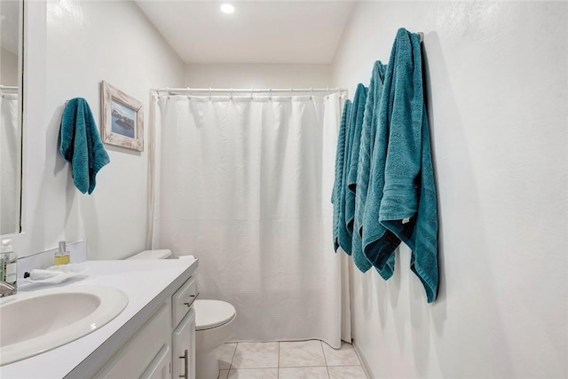 bathroom featuring toilet, vanity, and tile patterned flooring