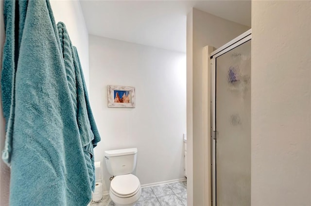 bathroom with toilet and a shower with door