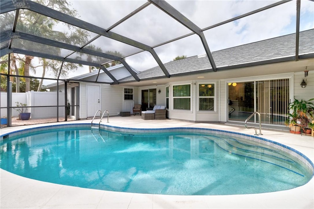 view of pool with a lanai and a patio