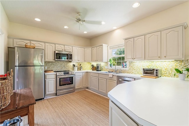 7387 61st St, Vero Beach, FL 32967 - kitchen featuring a ceiling fan, a sink, backsplash, appliances with stainless steel finishes, and recessed lighting