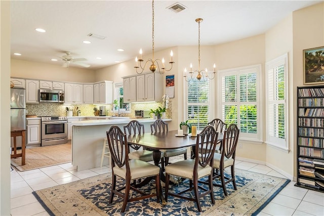 7387 61st St, Vero Beach, FL 32967 - dining area with plenty of natural light, visible vents, light tile patterned flooring, and ceiling fan with notable chandelier
