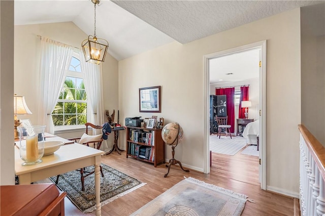 7387 61st St, Vero Beach, FL 32967 - office area with an inviting chandelier, vaulted ceiling, wood finished floors, and baseboards